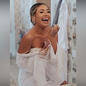 White satin robe with feathers.